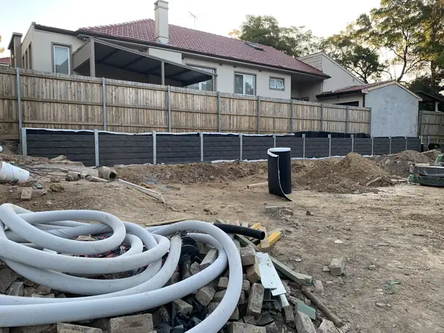 Coils of ag pipe on site ready for retaining wall drainage