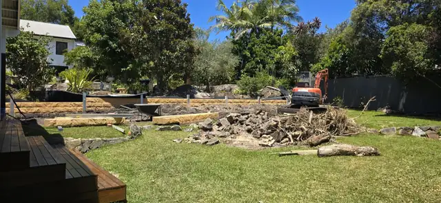 Sandstone-look retaining wall with new lawn and landscaping